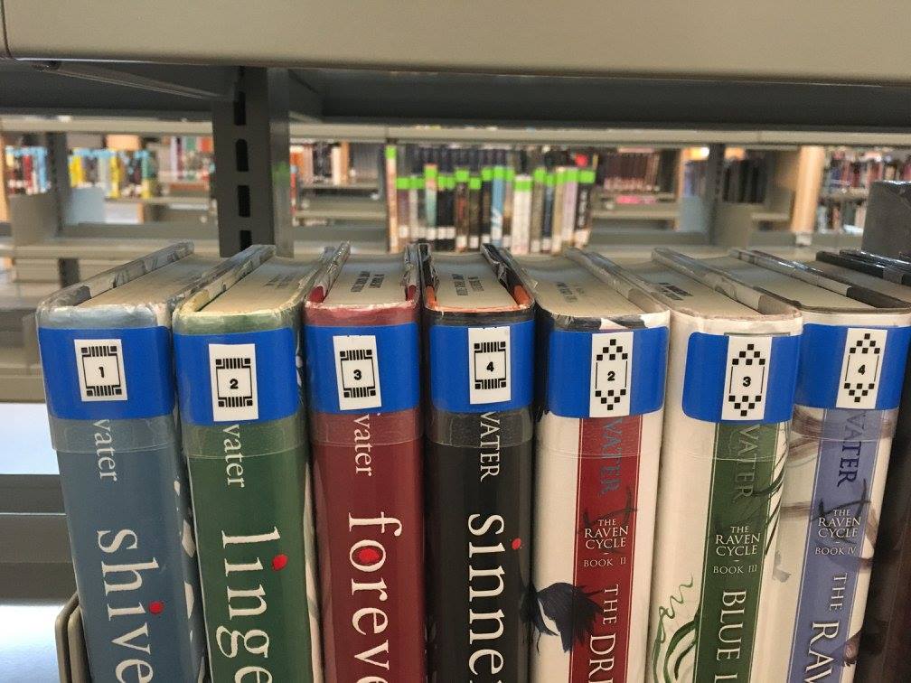 A close up view of books in a series with special labels to denote series order