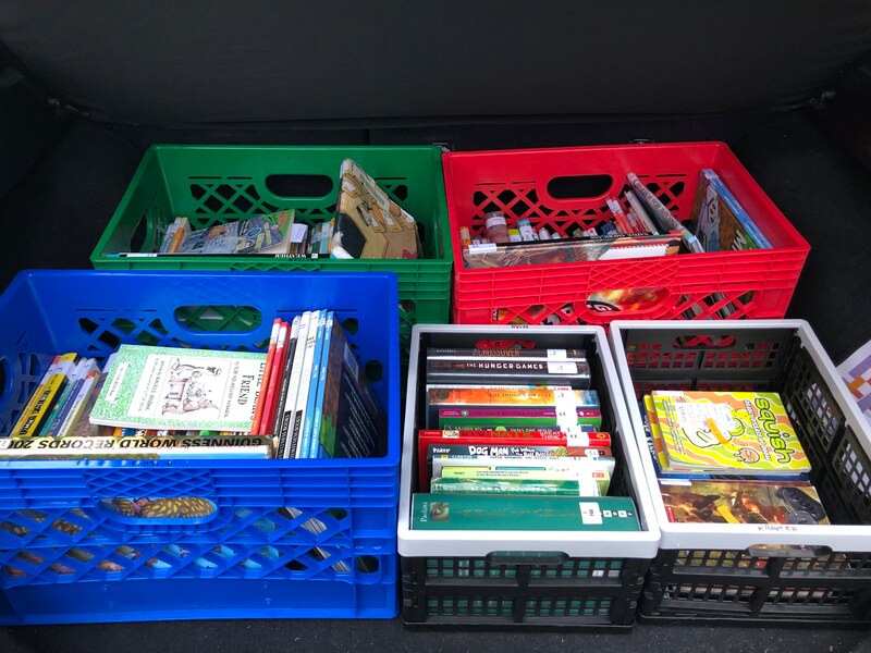 photo of crates full of books in the trunk of the car