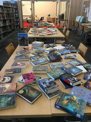 Tables are covered with books for a speed dating event